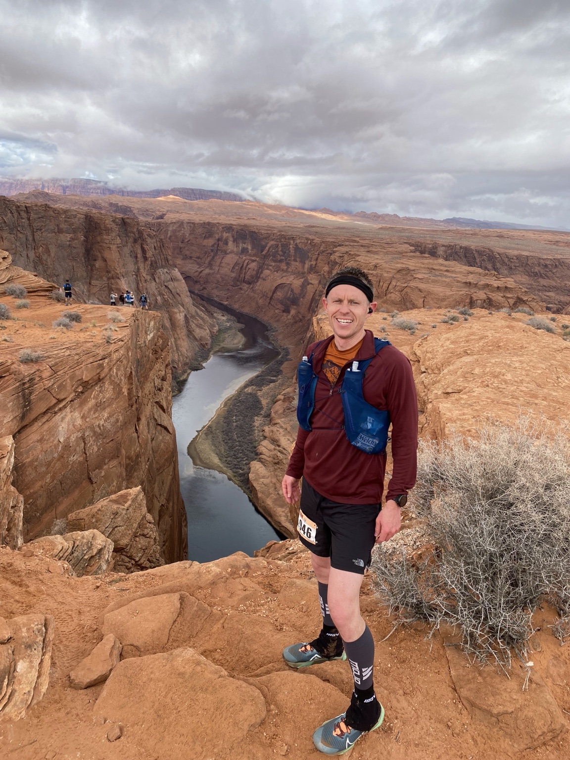 Trail runner overlooking a dramatic canyon